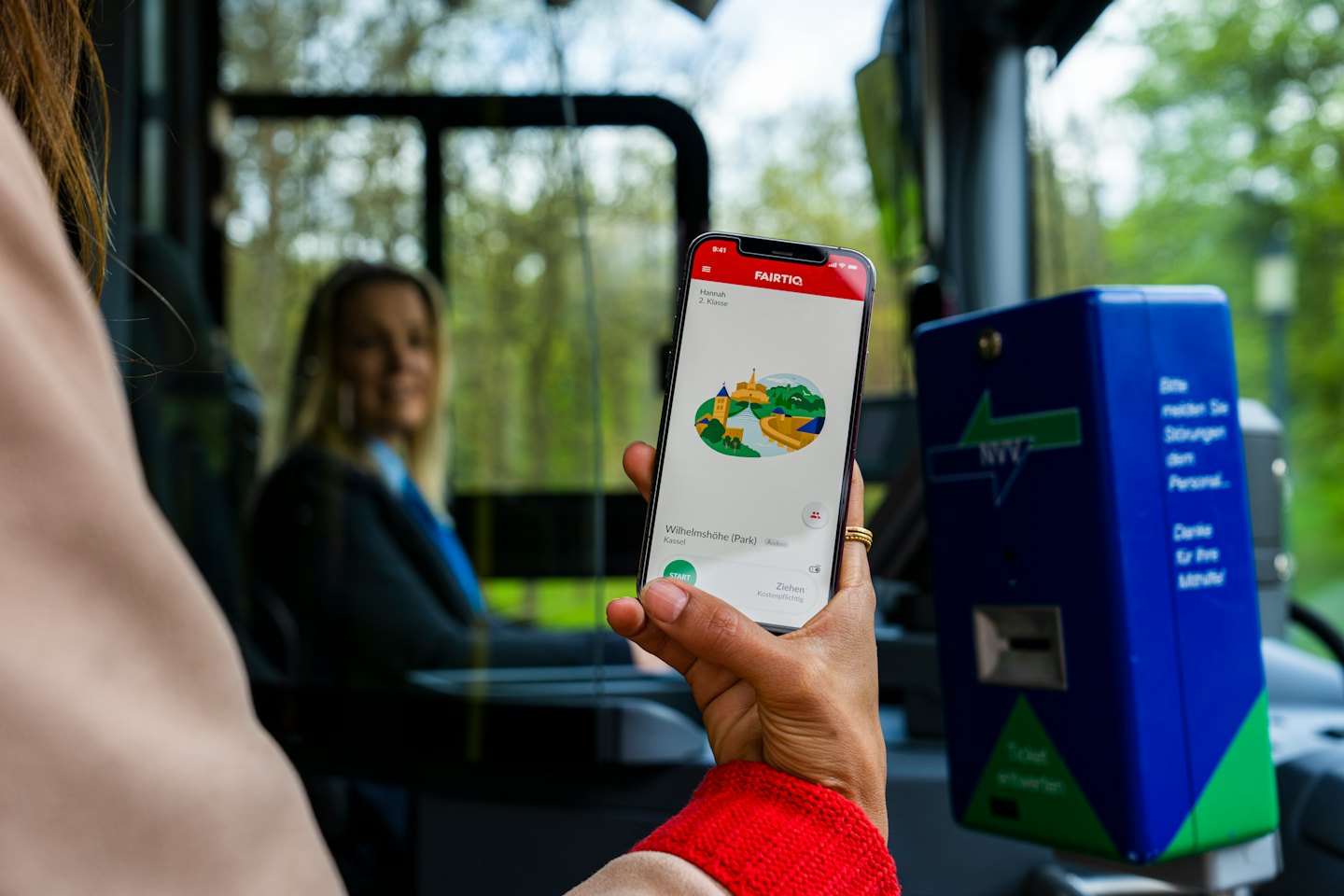 A passenger uses a transit app on their smartphone.